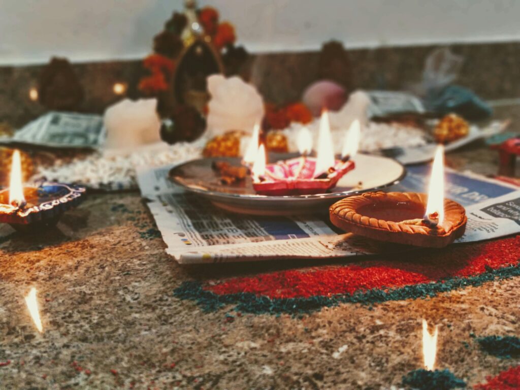 Close-up of candles and decorations on a table, capturing the essence of Diwali celebration indoors.